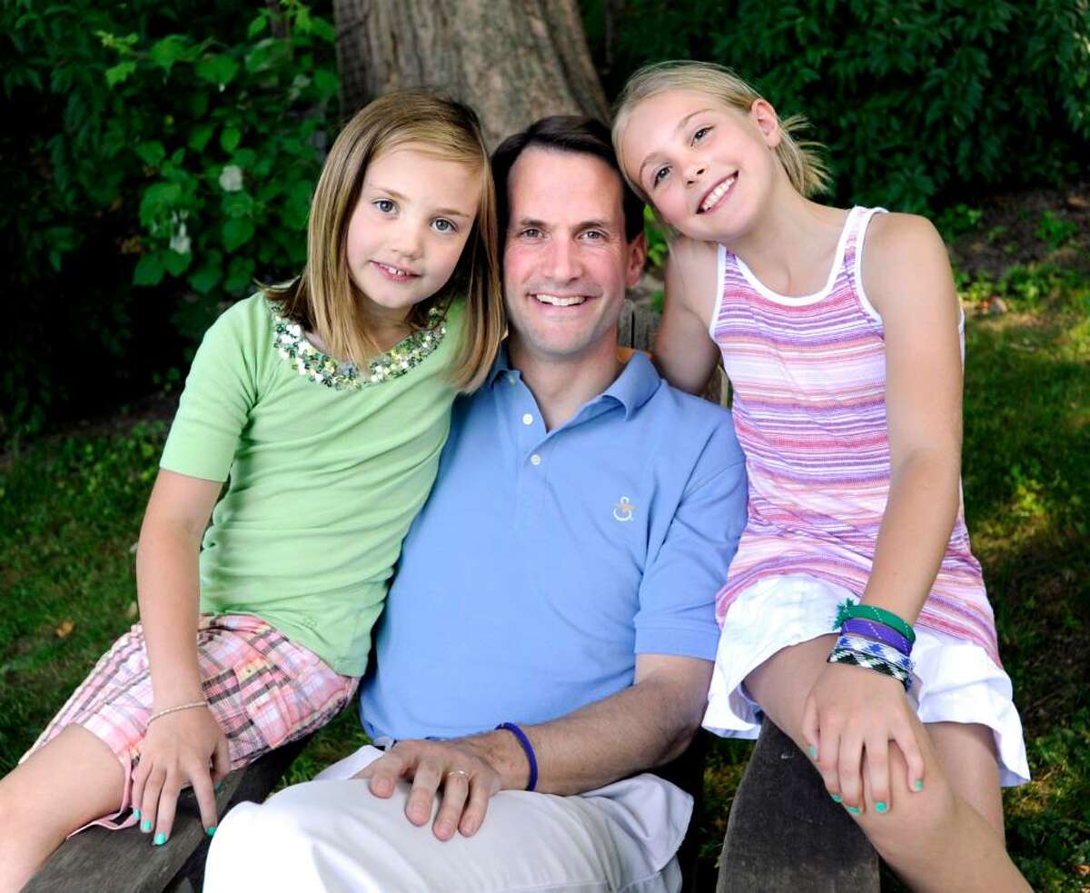 U.S. Rep. Jim Himes, D-Conn., poses with his daughters, Linley, 7, left, and Emma, 10, in the backyard of their Cos Cob home, Friday, June 18, 2010.
