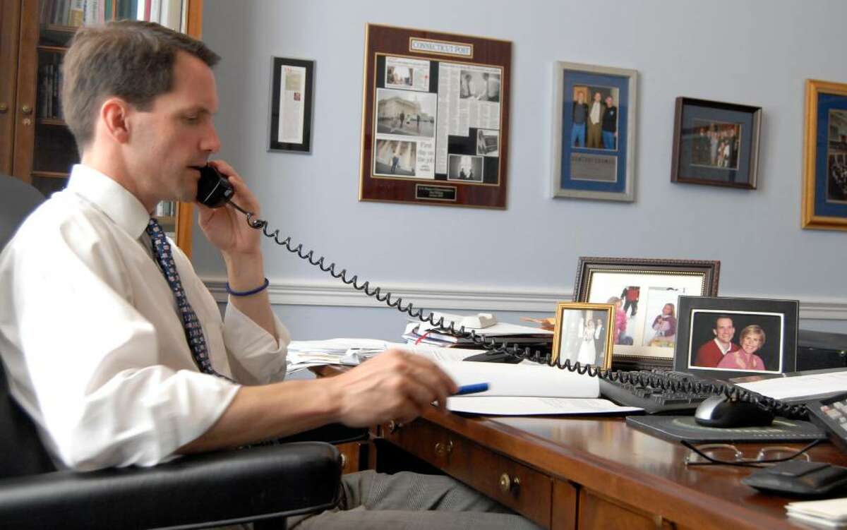 U.S. Rep. Jim Himes, D-Conn., in his Washington, D.C., office this past week. Family photos, from left, a wedding photo, photos of his two daughters and a photo of Himes and his wife Mary, are shown on his desk. Meredith McDermott/Contributed photo