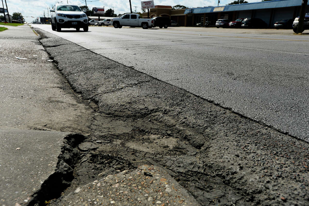 Motorists drive past a section of rough pavement on Nederland Avenue on Monday. The City of Nederland is proposing a complete overhaul of the street between Twin City Highway and U.S. 69. Photo taken Monday 10/17/16 Ryan Pelham/The Enterprise