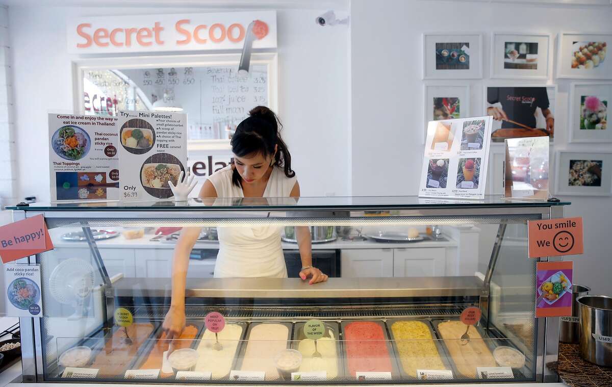 Secret Scoop Thai gelato founder Funn FIsher smoothes the trays of gelato flavors at her shop on Martin Luther King Jr. Boulevard in Berkeley, Calif. on Saturday, Aug. 5, 2017.