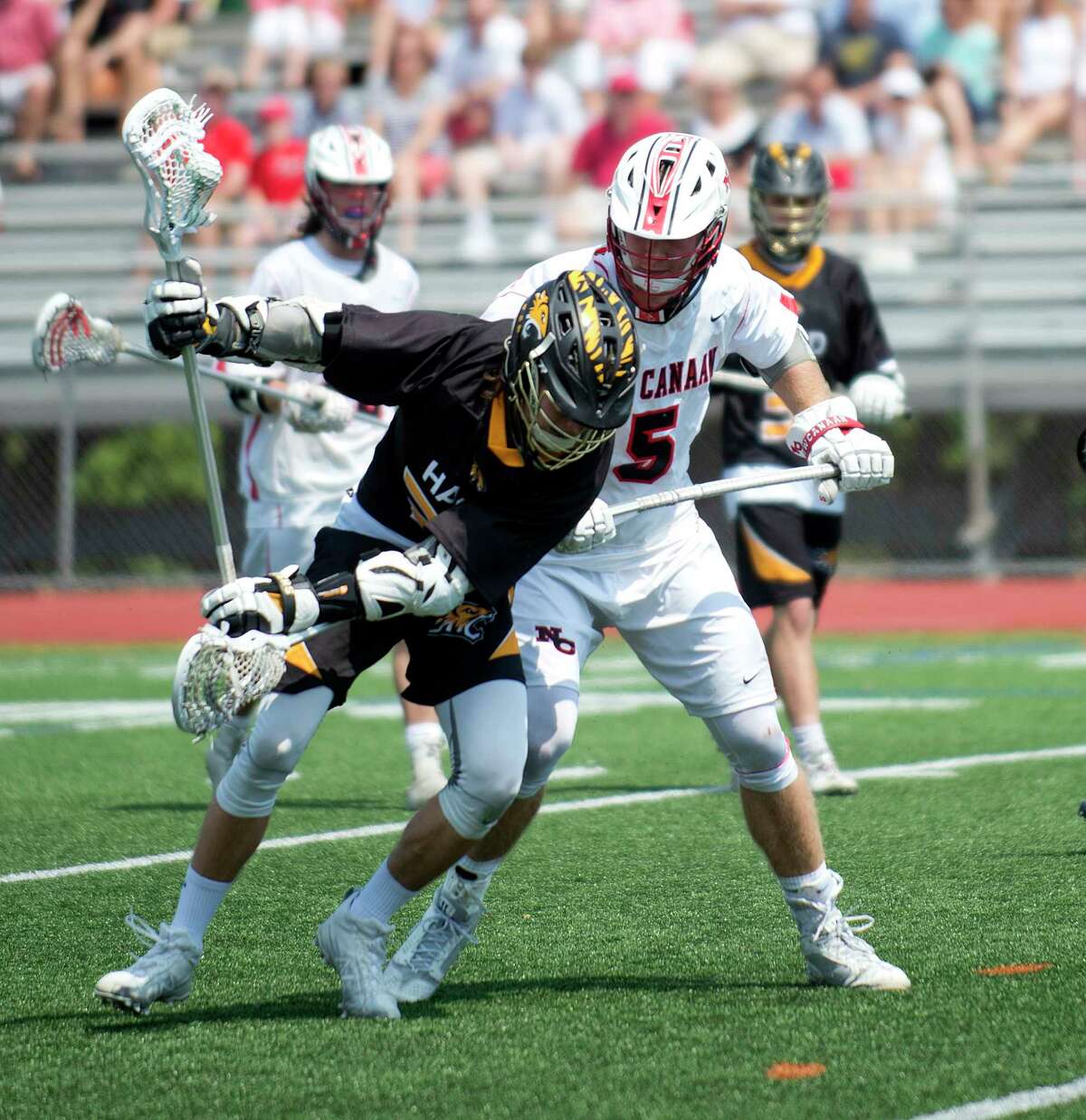 Daniel Hand's Liam Gottlick controls the ball as New Canaan's James Crovatto is close behind during the Class M Boys Lacrosse final at Brien McMahon High School in Norwalk, Conn., on Saturday, June 10, 2017.