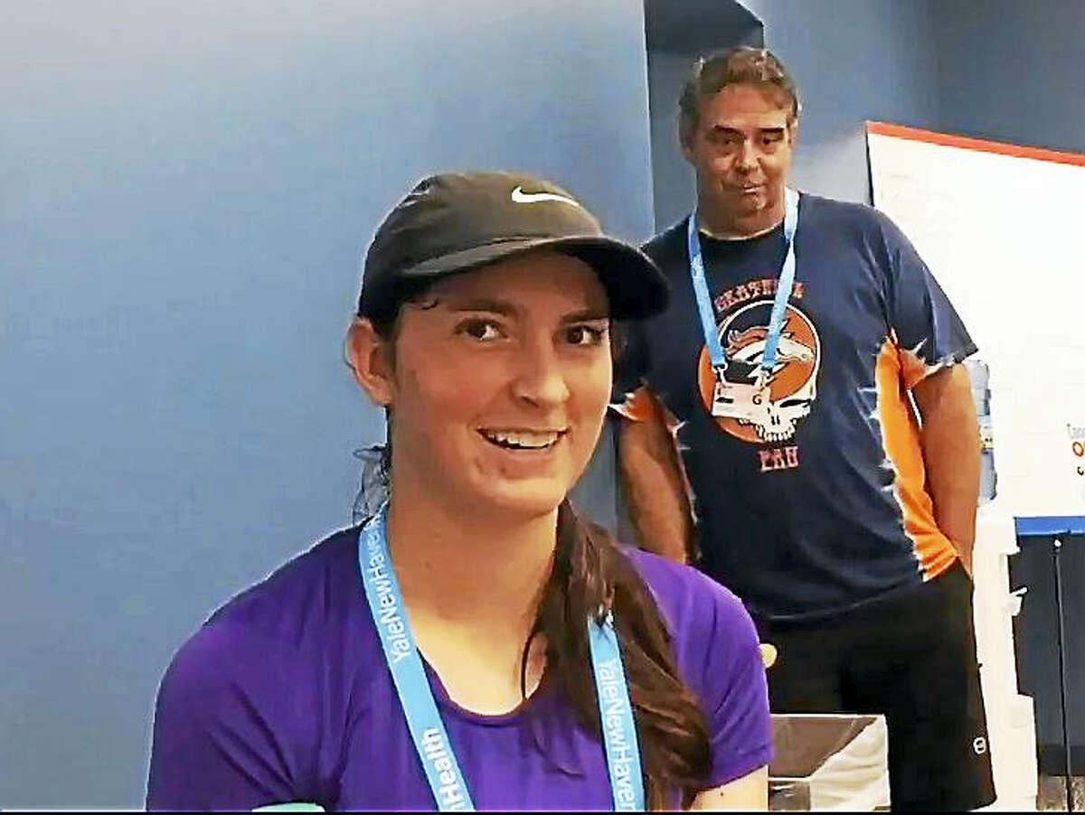 Incoming Yale freshman Samantha Martinelli talks with the media after her first career WTA match at the Connecticut Open on Friday. In the background is her father Angelo.