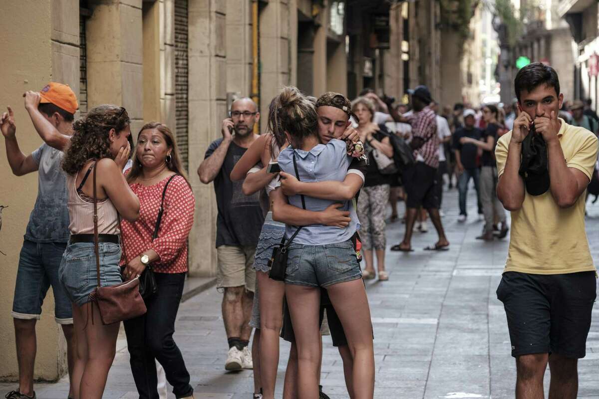 Two young people embrace minutes after a van drove through the crowds on Las Ramblas, Barcelona?’s most famous street, killing at least 12, on Aug. 17, 2017. At least 80 people were injured in what Spanish authorities described as a terrorist attack; two men have been arrested and the Islamic State group has already claimed responsibility. (Sergi Alcazar/El Nacional via The New York Times) -- NO SALES; FOR EDITORIAL USE ONLY WITH STORY SLUGGED BARCELONA-CRASH FOR AUG. 18, 2017. ALL OTHER USE PROHIBITED. ?—