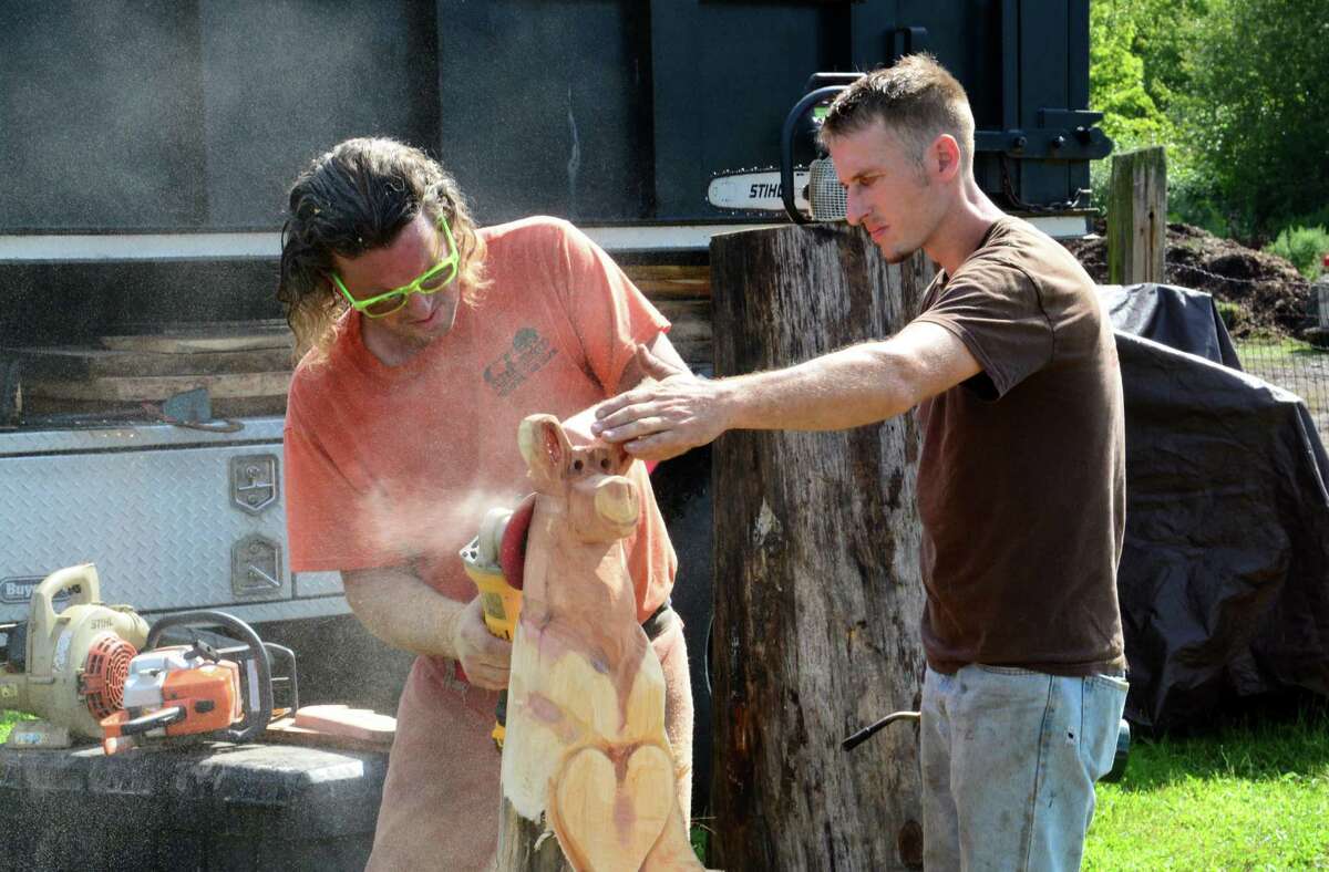 Jay Dubac, from Vermont, left, and CJ Payne from Seymour, CT. carve a moose out of wood durng the Bridgewater Country Fair on Saturday, August 19, 2017.