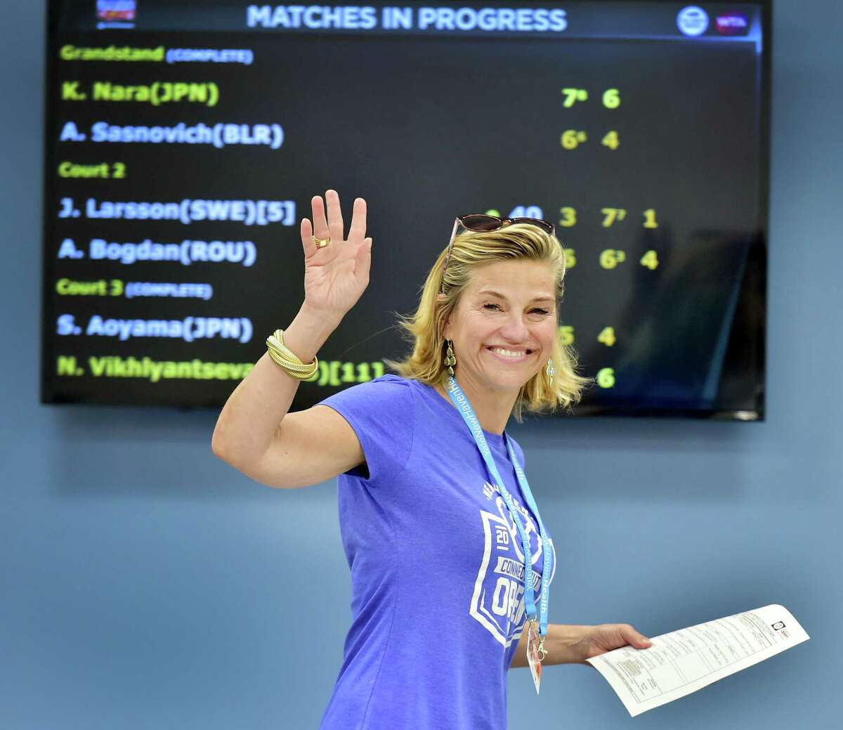 (Peter Hvizdak / Hearst Connecticut Media) New Haven,Connecticut: Saturday, August 19, 2017. Connecticut Open tournament director Anne Worcester waves to a photographer Saturday afternoon in the Media Center at the Connecticut Open tennis tournament.