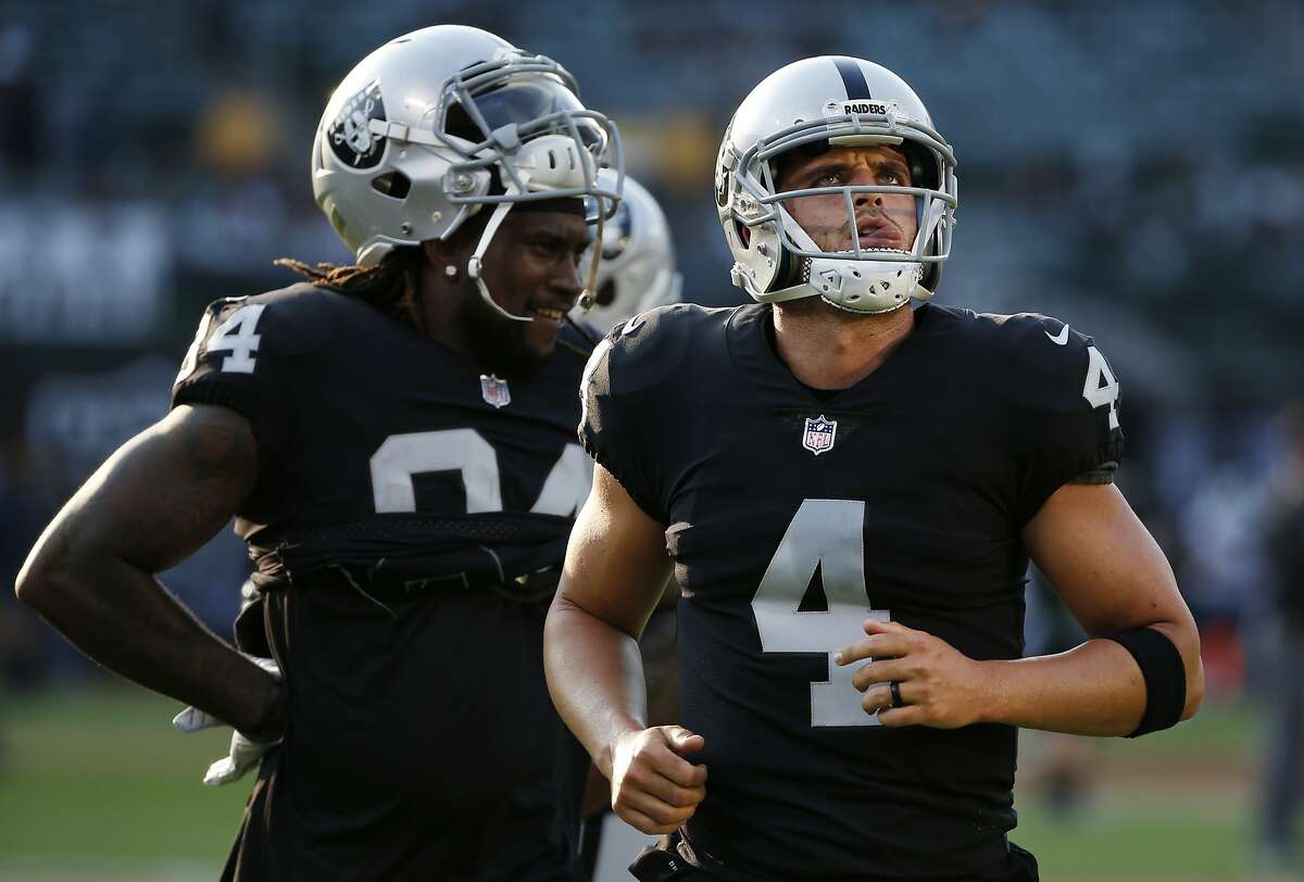 Oakland Raiders quarterback Derek Carr (4) and Oakland Raiders wide receiver Cordarrelle Patterson (84) before the start of an NFL preseason football game between the Oakland Raiders and the Los Angeles Rams on Saturday, Aug. 19, 2017, at the Oakland Coliseum in Oakland, Calif.