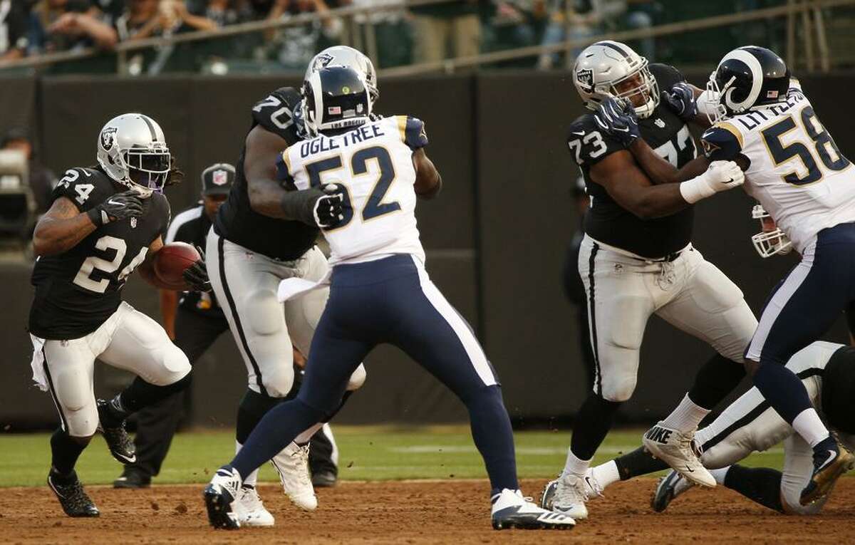 Raiders running back Marshawn Lynch (left) got his first action of the preseason, playing one series against the Rams.