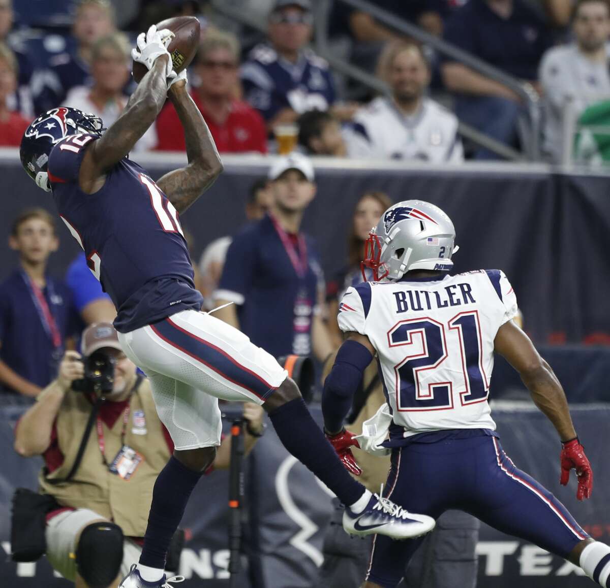Houston Texans wide receiver Bruce Ellington (12) leaps over New England Patriots cornerback Malcolm Butler (21) for a 37-yard reception during the first quarter of an NFL preseason game at NRG Stadium, Saturday, Aug. 19, 2017, in Houston. ( Karen Warren / Houston Chronicle )