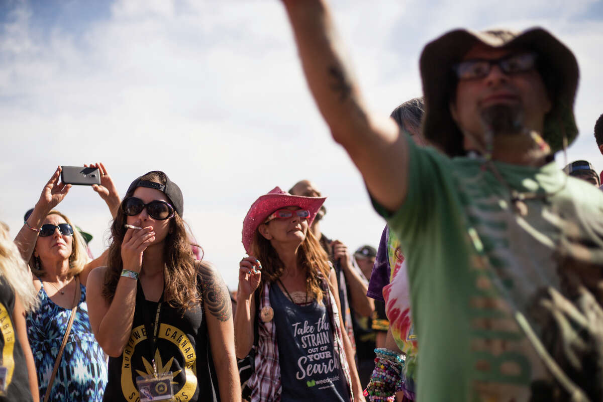 The crowd cheers at the MainStage as the clock hits 4:20 during Hempfest at Myrtle Edwards Park on Sunday, Aug. 20, 2017.