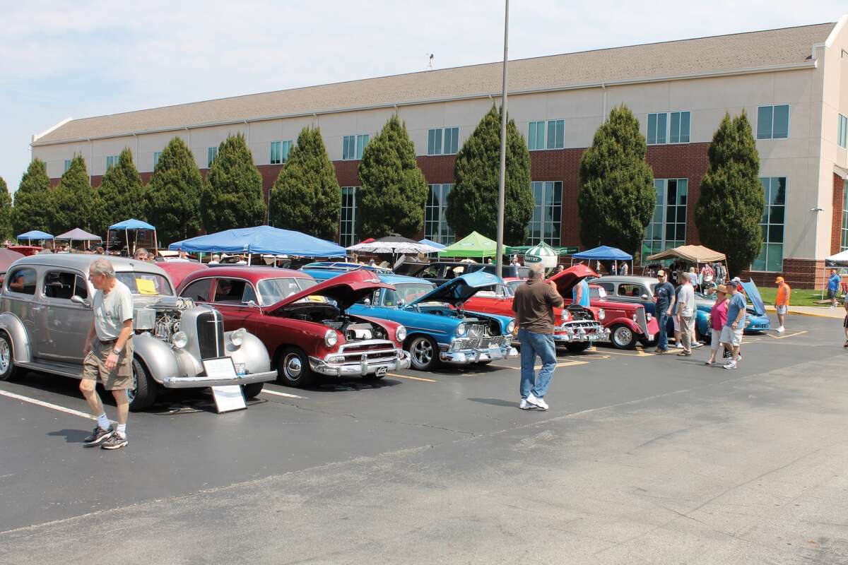 Visitors browse some of the classics that were entered into the 26th Annual D.A.R.E. Car Show Sunday, which took place at Edwardsville High School. The event raises funds for the Edwardsville Police Department's Drug Abuse Resistance Awareness (D.A.R.E.) program, which is taught to youngsters in District 7-area schools.