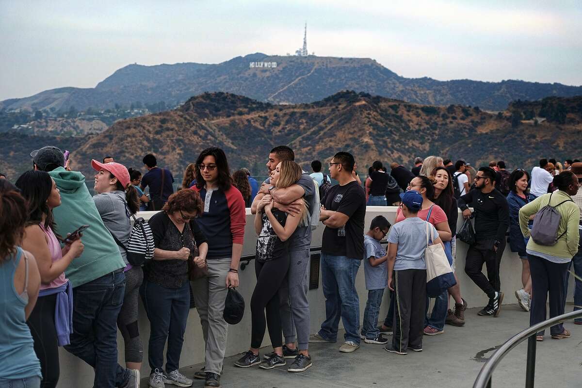 People wait in line to buy viewing glasses for the eclipse at the Griffith Observatory in Los Angeles early Monday, Aug. 21, 2017. (AP Photo/Richard Vogel)