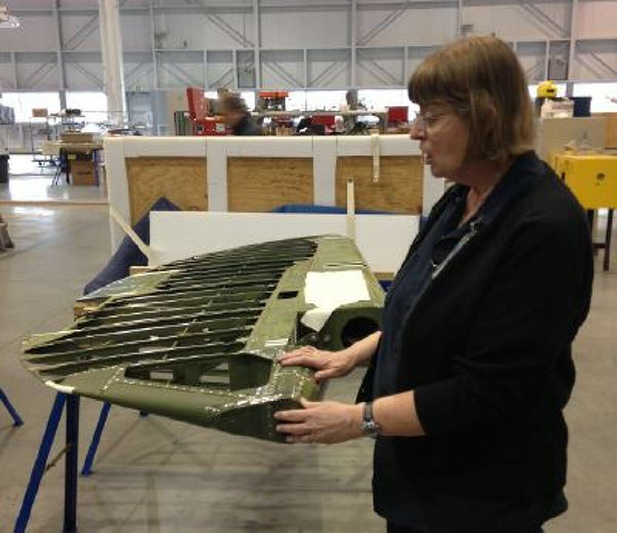 Restoration specialist Anne McCombs discusses how she will restore part of a World War II-era plane's rudder for display at the Smithsonian National Air and Space Museum's Udvar-Hazy Center.