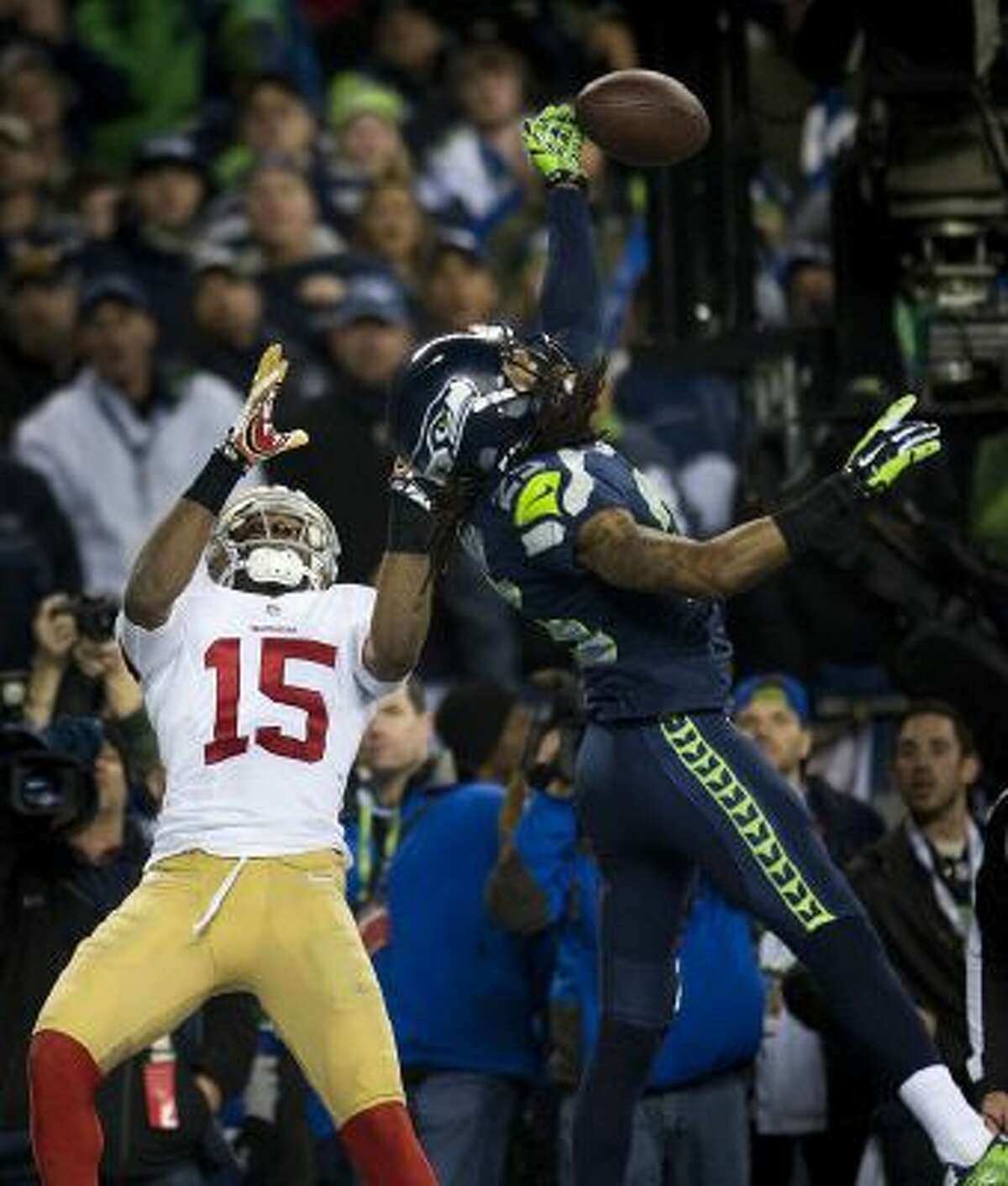 Seattle Seahawks cornerback Richard Sherman (25) hits the ball away from San Francisco 49ers wide receiver Michael Crabtree (15) and is intercepted by Seattle Seahawks outside linebacker Malcolm Smith (53) during the NFC Championship game.