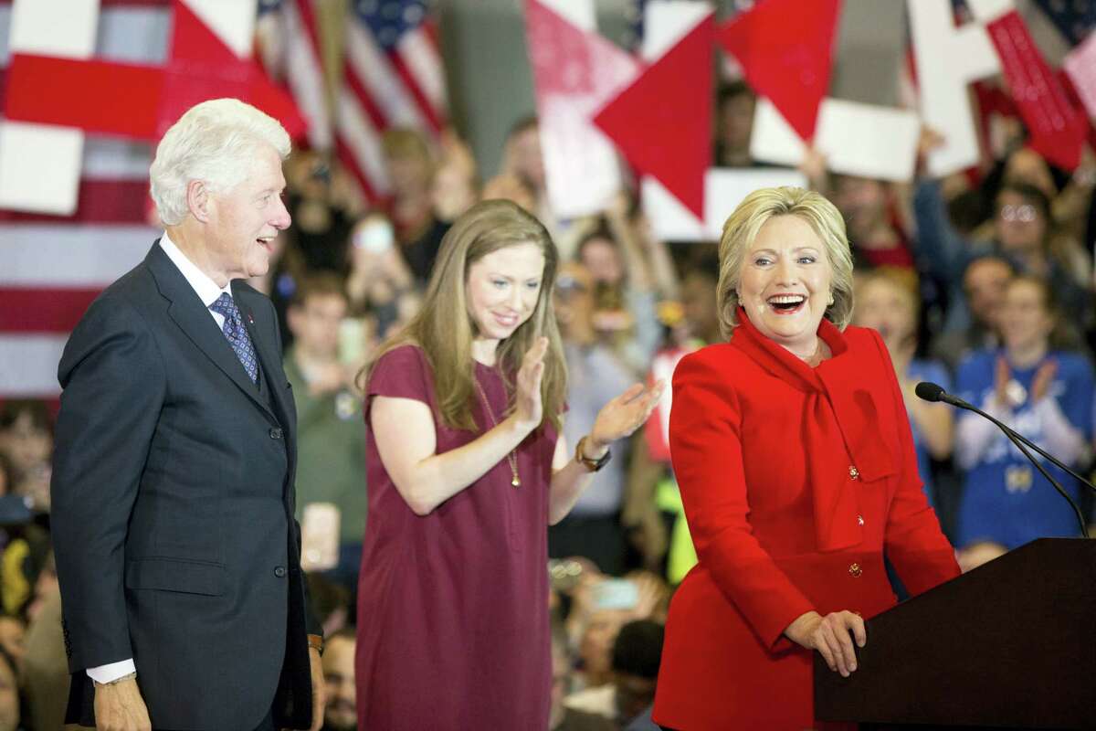 Democratic presidential candidate Hillary Clinton, accompanied by former President Bill Clinton and their daughter Chelsea Clinton, arrives at her caucus night rally at Drake University in Des Moines, Iowa, Monday.
