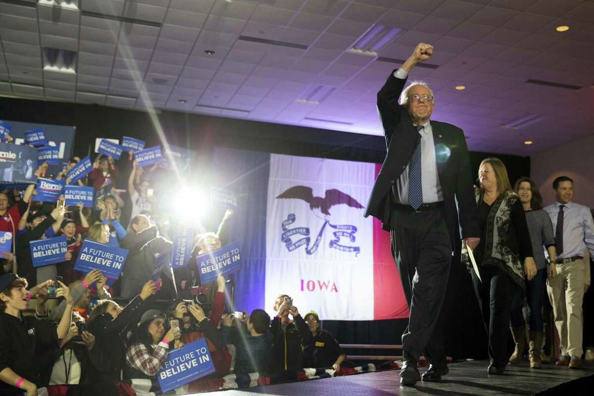 Democratic presidential candidate Sen. Bernie Sanders, I-Vt., arrives for a caucus night party Monday in Des Moines, Iowa.
