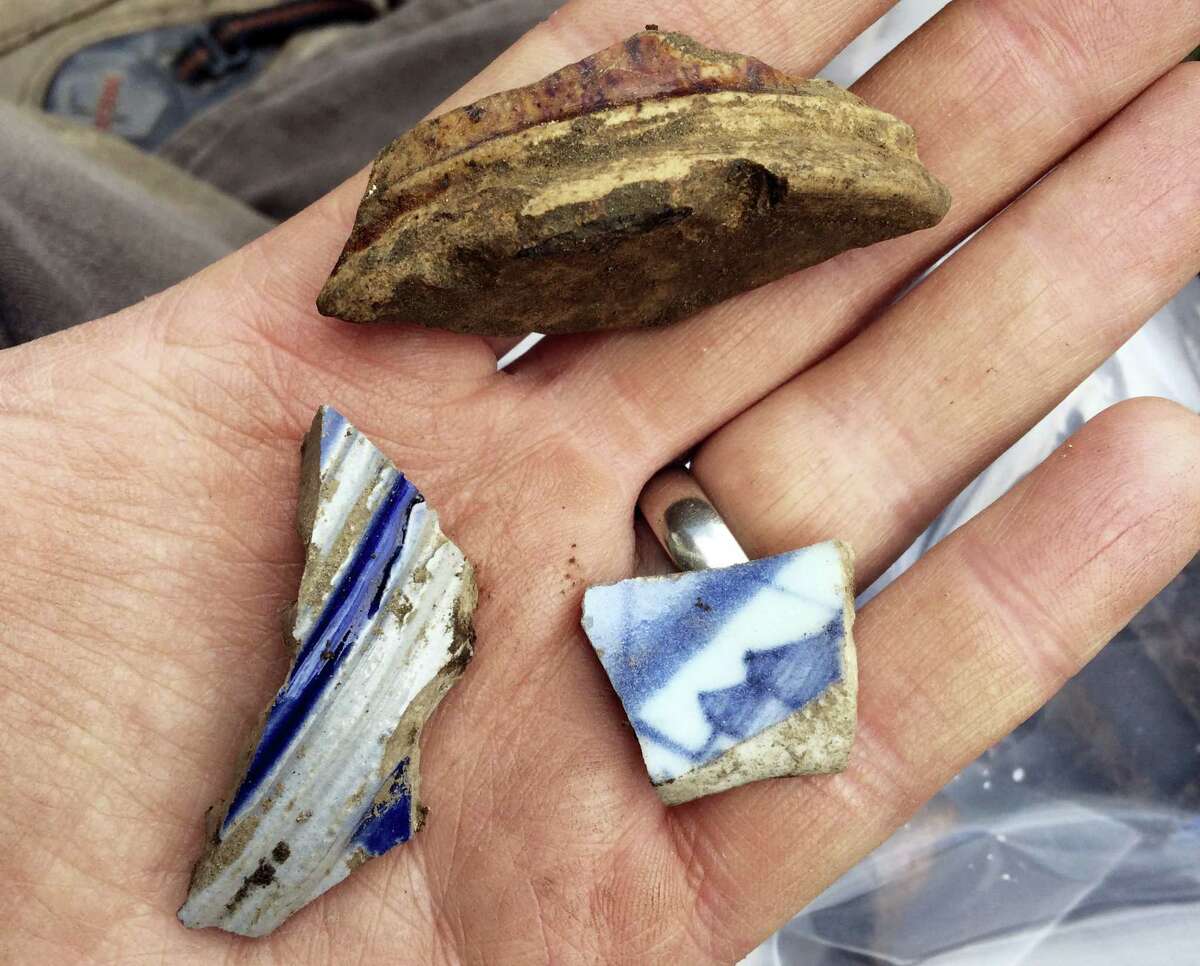 This April 8, 2016 photo provided by the City of Boston shows artifacts recovered from an archeological dig at the home where slain African-American activist Malcolm X lived part of his teen years with his sister's family in the 1940s in the Roxbury section of Boston, when he was known as Malcolm Little. City archeologist Joseph Bagley said that a two-week dig at the home, in an effort to learn more about his early life, uncovered evidence of an older settlement dating to the 1700s that they hadn't expected to find. After weather delays, the dig is set to resume on May 16. (Joseph Bagley/City of Boston via AP)