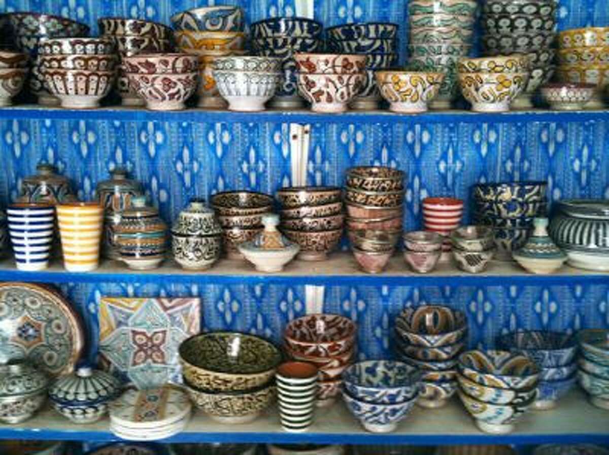 Painted pottery for sale in the souks of Essaouira, Morocco, where visitors can haggle for their souvenirs.