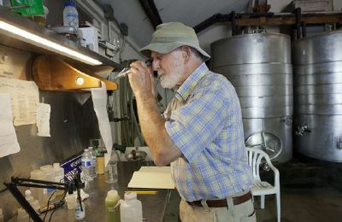 Retzlaff Winery owner Bob Taylor uses a refractometer to check the sugar level of Sauvignon Blanc grapes at Retzlaff Winery in Livermore, Calif., on Thursday, August 15, 2013.