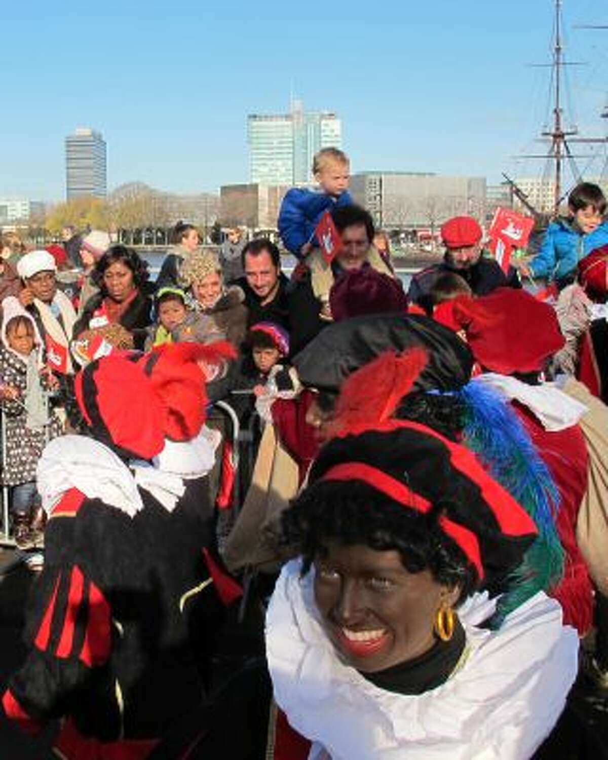 In this Nov. 18, 2012 file photo persons dressed as "Zwarte Piet" or "Black Pete" attend a parade after St. Nicholas, or Sinterklaas, arrived by boat in Amsterdam, Netherlands.