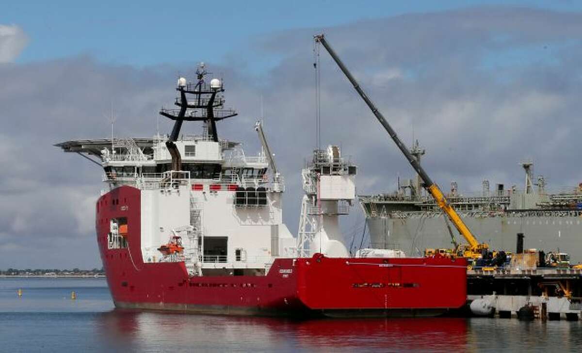 Australian defense ship Ocean Shield lies docked at naval base HMAS Stirling while being fitted with a towed pinger locator to aid in her roll in the search for missing Malaysia Airlines Flight MH370 in Perth, Australia, Sunday, March 30, 2014. The Australian warship with an aircraft black box detector was set to depart Sunday to join the search. It will still take three to four days for the ship, the Ocean Shield, to reach the search zone - an area roughly the size of Poland about...