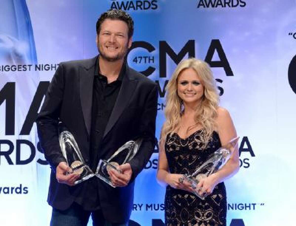 Blake Shelton, left, and Miranda Lambert pose backstage with their awards for male vocalist of the year, album of the year and female vocalist of the year at the 47th annual CMA Awards at Bridgestone Arena on Wednesday, Nov. 6, 2013, in Nashville, Tenn.