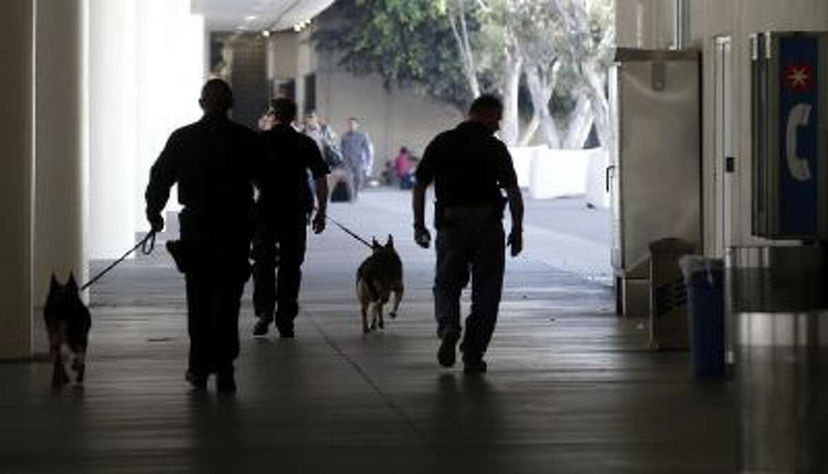 Police check the area around Terminal 1 at Los Angeles International Airport on Friday, Nov. 1, 2013.