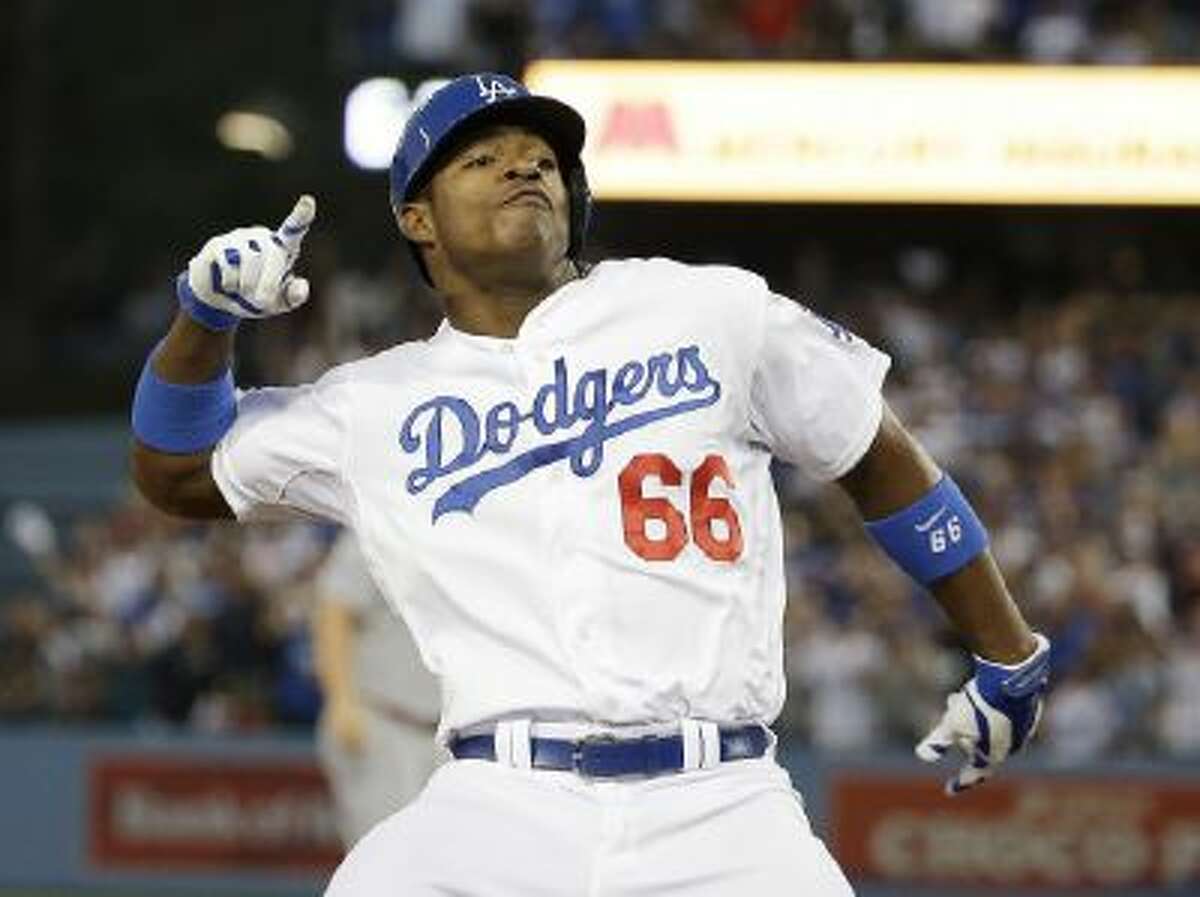 Los Angeles Dodgers' Yasiel Puig reacts after hitting a run-scoring triple during the fourth inning of Game 3.