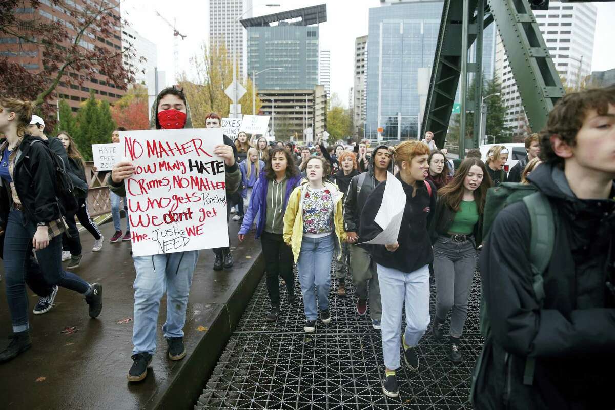 FILE--In this Nov. 14, 2016, file photo, Portland Public School students walk out of schools and converge on Pioneer Courthouse Square for a protest against the results of last week's presidential election. Almost 800 teenagers between the ages of 13 and 17 have participated in a first-of-its-kind Associated Press-NORC Center for Public Affairs poll on teens' social media use, political views and political outlook. (Beth Nakamura/The Oregonian via AP)