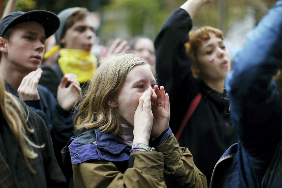 FILE--In this Nov. 14, 2016, file photo, Portland Public School students walked out of schools and converge on Pioneer Courthouse Square for a protest against the results of last week's presidential election. Almost 800 teenagers between the ages of 13 and 17 have participated in a first-of-its-kind Associated Press-NORC Center for Public Affairs poll on teens' social media use, political views and political outlook. (Beth Nakamura/The Oregonian via AP)