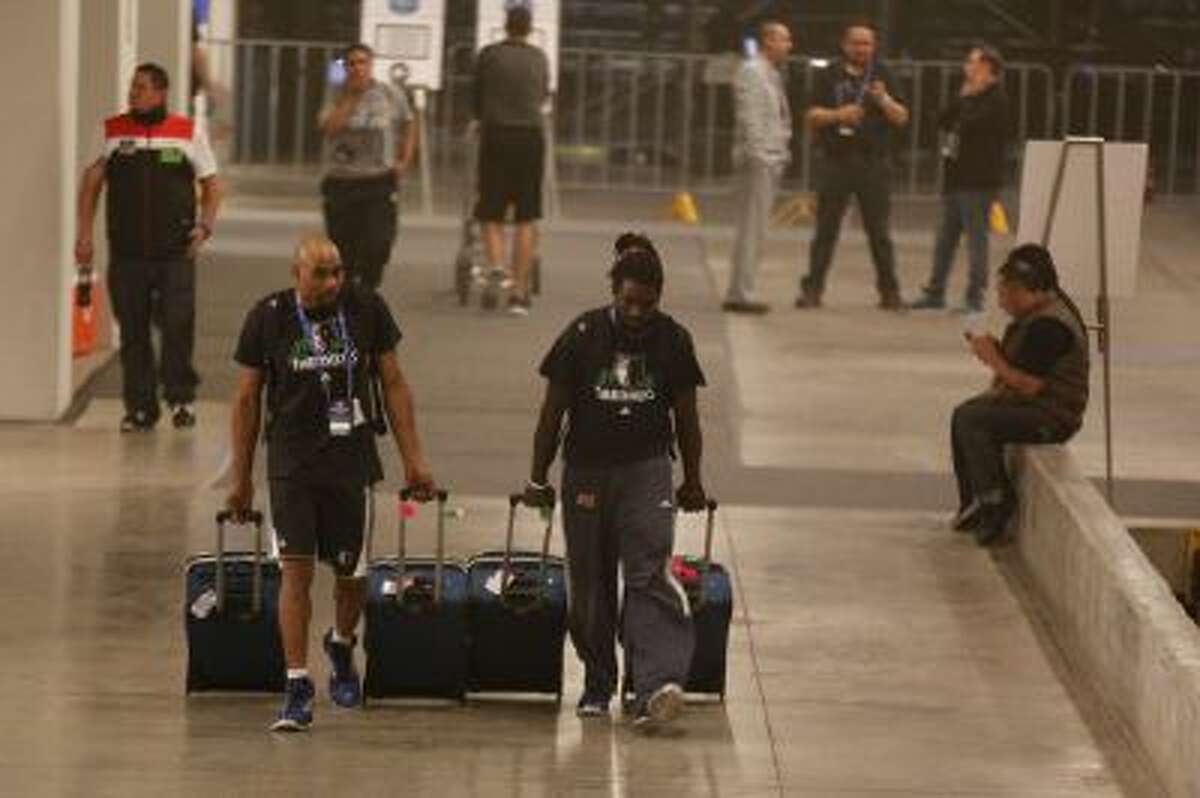 Members of the Minnesota Timberwolves team evacuate The Mexico City arena in Mexico City, Wednesday, Dec. 4, 2013