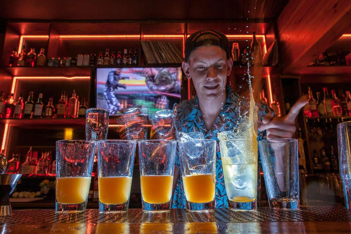 Bar tender Keller Johnson sets off the sequence for a Gladiator Drop at B-Side bar in Sacramento, California, USA 15 Aug 2017. Gladiator Drop - Absolut Mandrin, Peach Schnapps, Red Bull, Orange juice. (Peter DaSilva/Special to The Chronicle)