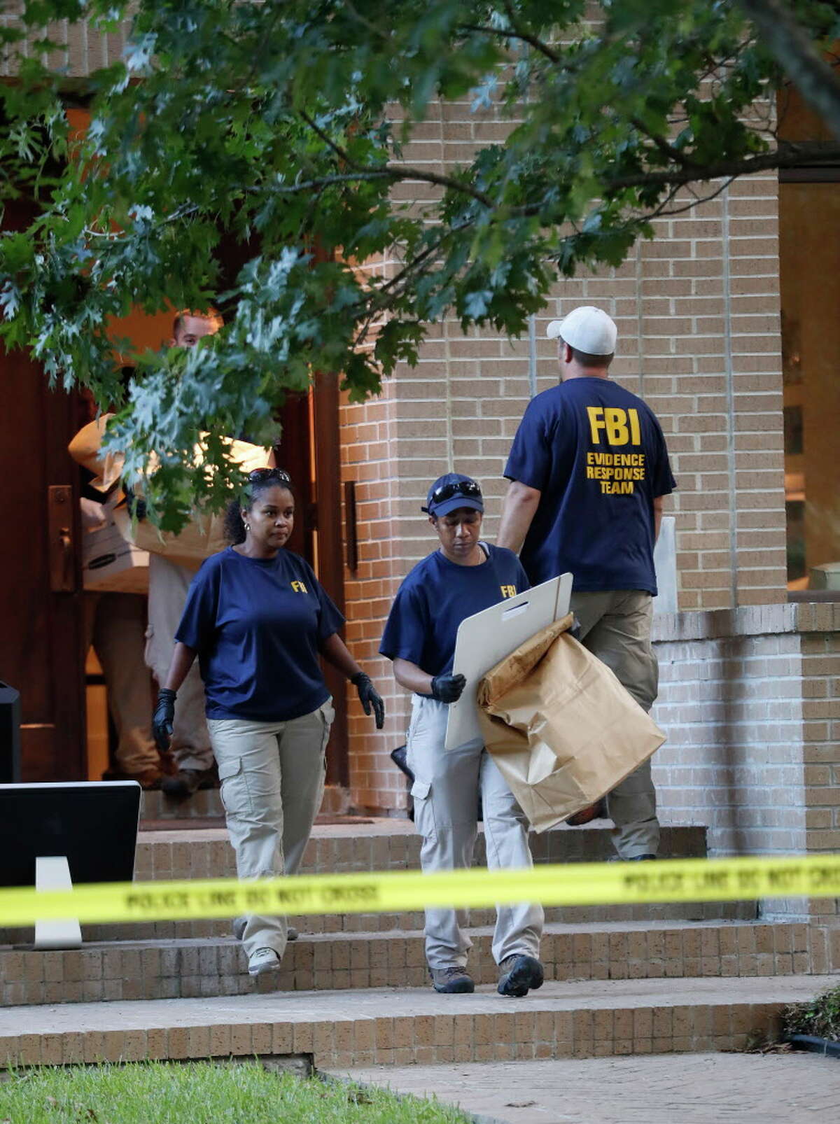 FBI agents take bags of evidence out of a house at 2025 Albans, Monday, Aug. 21, 2017, in Houston. Earlier in the day, the ATF, FBI and Houston Police conducted a controlled explosion at the house next door at 2021 Albans.