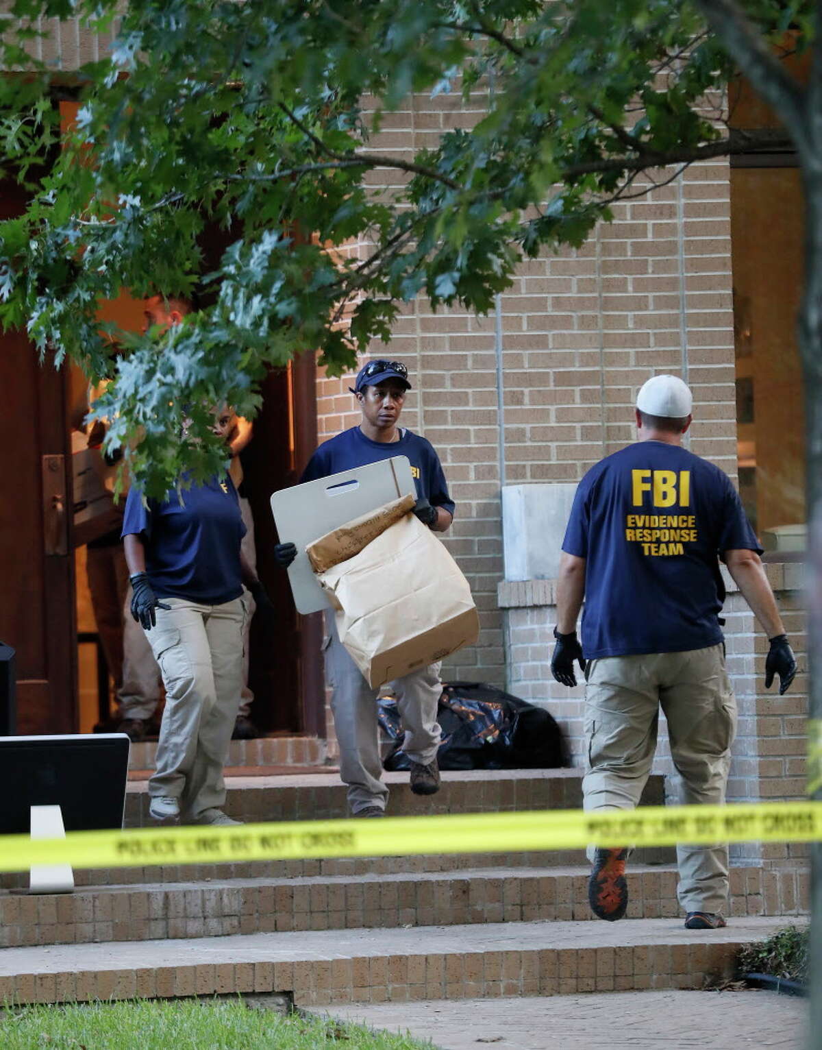 FBI agents take bags of evidence out of a house at 2025 Albans, Monday, Aug. 21, 2017, in Houston. Earlier in the day, the ATF, FBI and Houston Police conducted a controlled explosion at the house next door at 2021 Albans.
