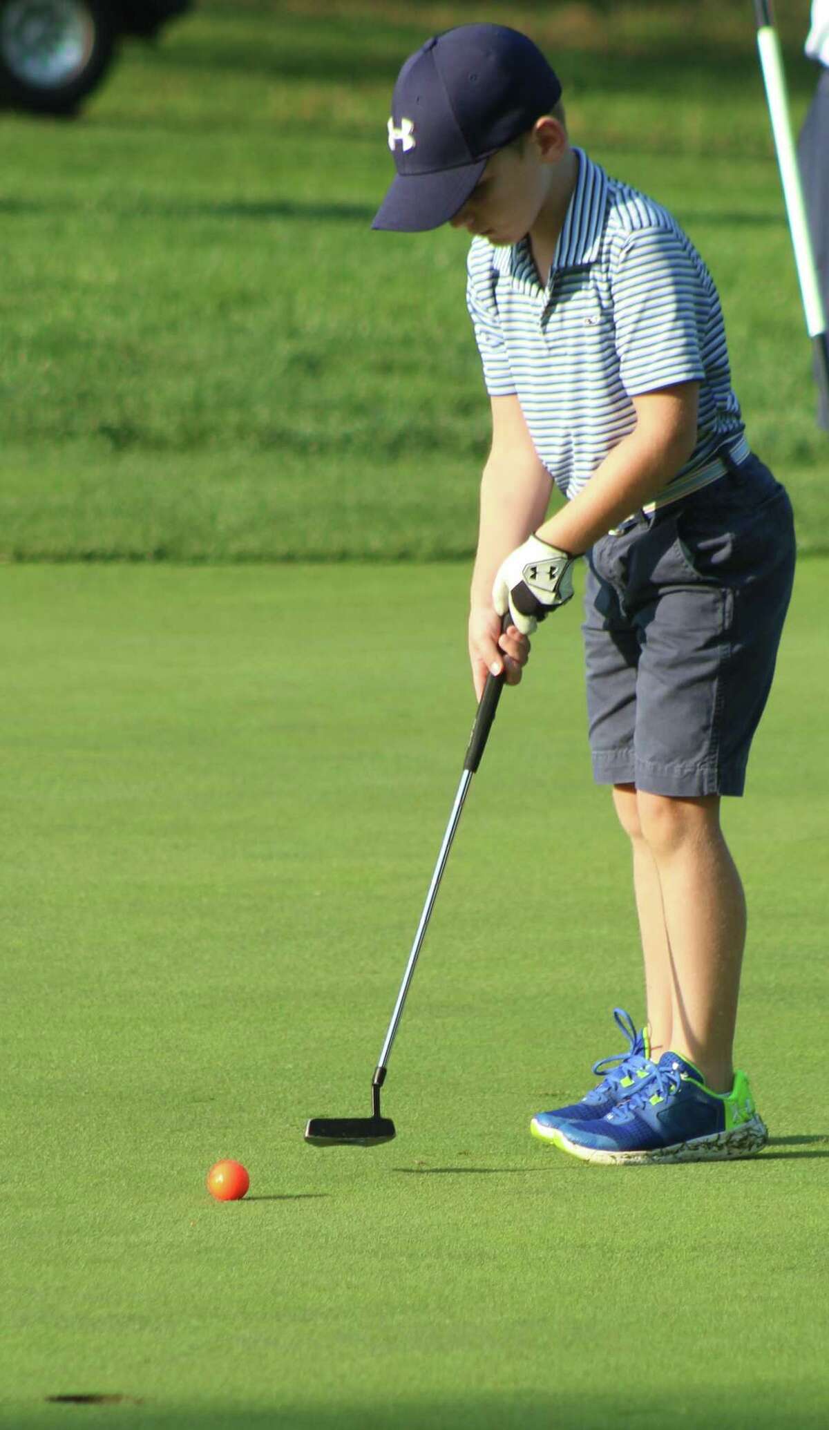 Jack Schonfeld putts on the 18th green at the Fran McCarthy Junior Golf Tournament at Richter Park Golf Course in Danbury Aug. 21, 2017.