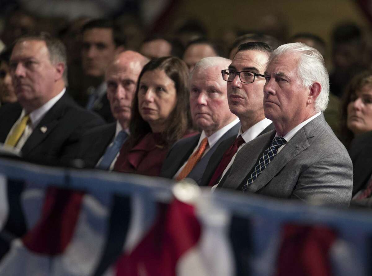 From right, Secretary of State Rex Tillerson, Treasury Secretary Steven Mnuchin, and Attorney General Jeff Sessions look to President Donald Trump as he speaks at Fort Myer in Arlington Va., Monday, Aug. 21, 2017, during a Presidential Address to the Nation about a strategy he believes will best position the U.S. to eventually declare victory in Afghanistan. (AP Photo/Carolyn Kaster)