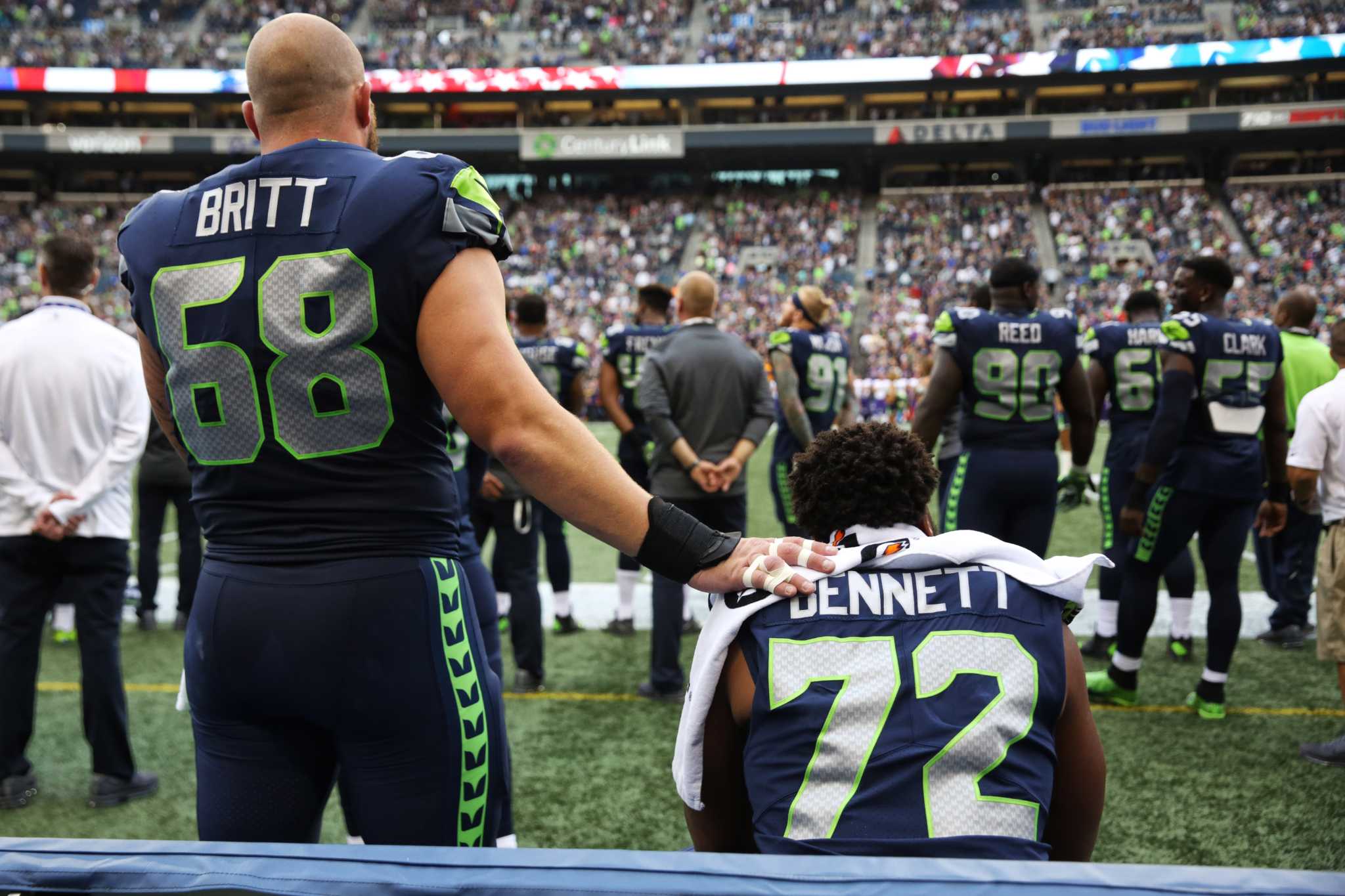 In this Dec. 10, 2017, file photo, San Francisco 49ers' Eli Harold (57),  Eric Reid (35) and Marquise Goodwin (11) kneel during the national anthem  before an NFL football game against the