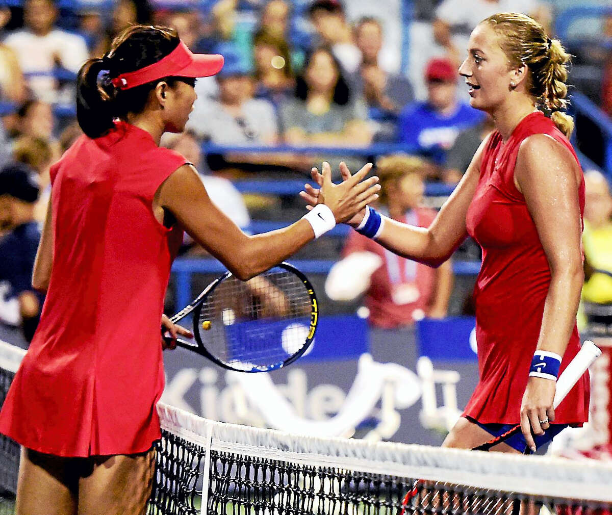 Shuai Zhang of China shakes hands with Petra Kvitova of the Czech Republic after defeating Kvitova 6-2, 6-1 during the first round of the Connecticut Open tennis tournament on Stadium Court at the Connecticut Tennis Center in New Haven.