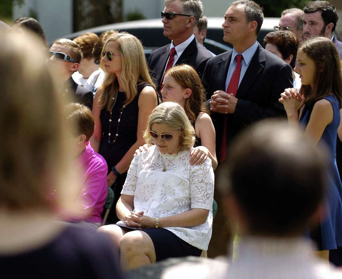 Madeline Galgano places her hand on the shoulder of her mother, Anmarie Galgano, as they attend a Military honors burial for Galgano's Uncle, Patrick J. Byrnes, known as "Bud," at Queen of Peace Cemetery on Saturday, August 19, 2017 in Stamford, Connecticut. Byrnes was killed in action in 1943 at the age of 23. His remains were recently identified by the U.S. Army and returned to his family.