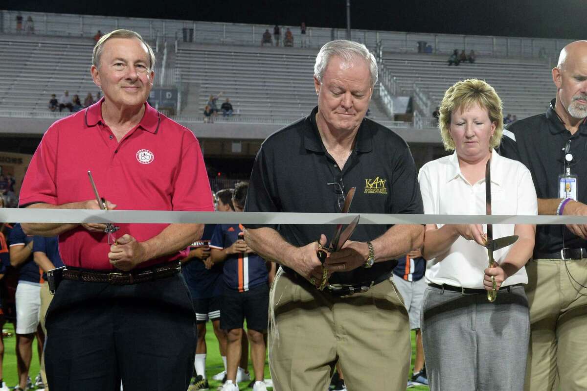 Chuck Brawner, City of Katy Mayor (Left), Mike Johnson and Debbie Decker, Executive Director of Athletics cut a ribbon to dedicate Katy ISD's Mike Johnson Field and Legacy Stadium in Katy, TX on August 17, 2017.