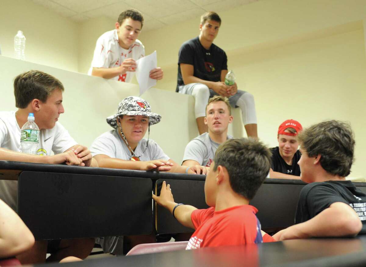 GHS junior Joe Kraninger, center, discusses a video shown by the anti-domestic violence nonprofit One Love with fellow football players during a presentation at Greenwich High School in Greenwich, Conn. Tuesday, Aug. 22, 2017. One Love discussed how to recognize and prevent domestic violence while showing videos and holding small group workshops.