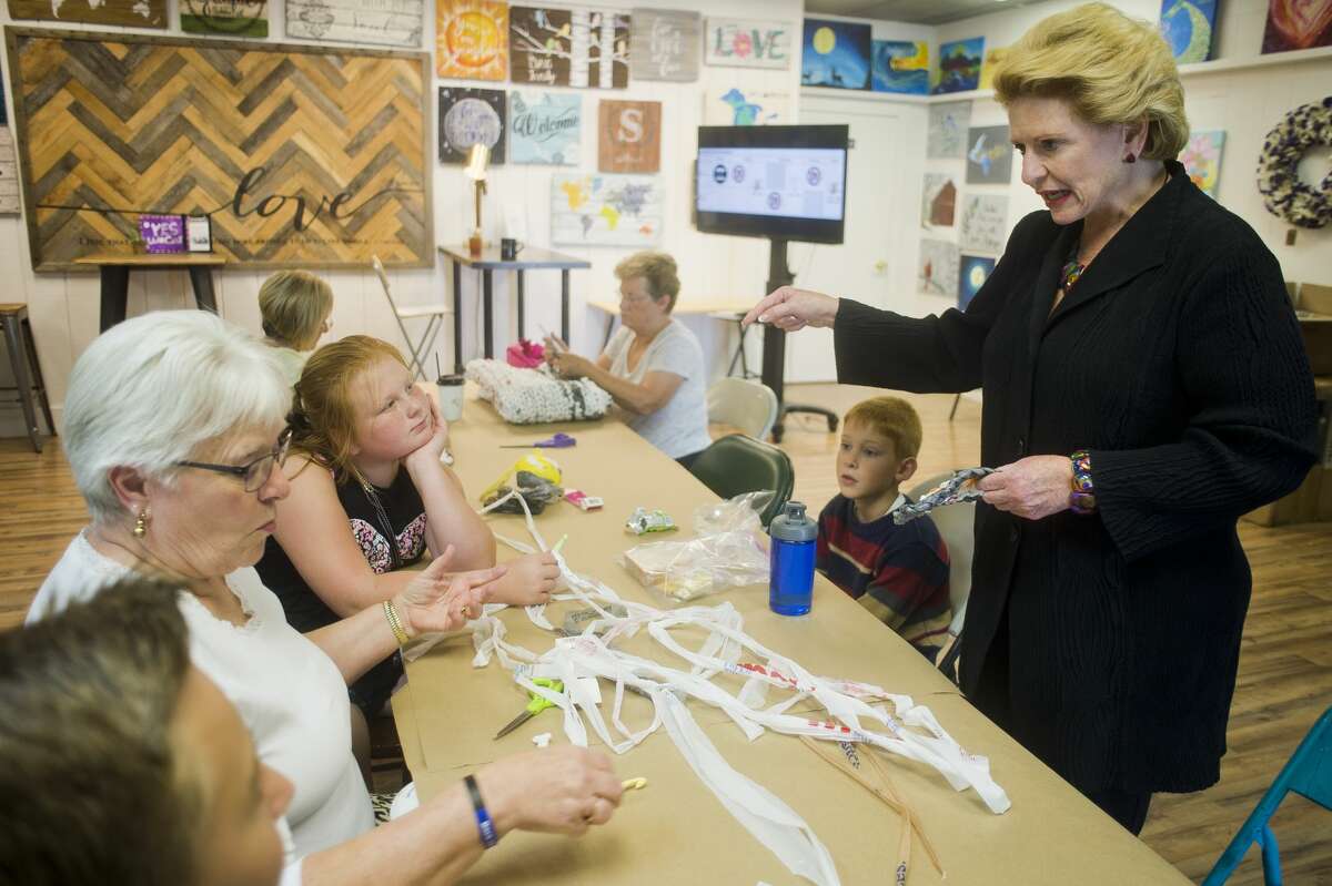 U.S. Sen. Debbie Stabenow chats with a summer camp group as they work on a craft at Live Oak Coffeehouse during an afternoon of visiting small businesses in Midland on Wednesday, August 23, 2017.
