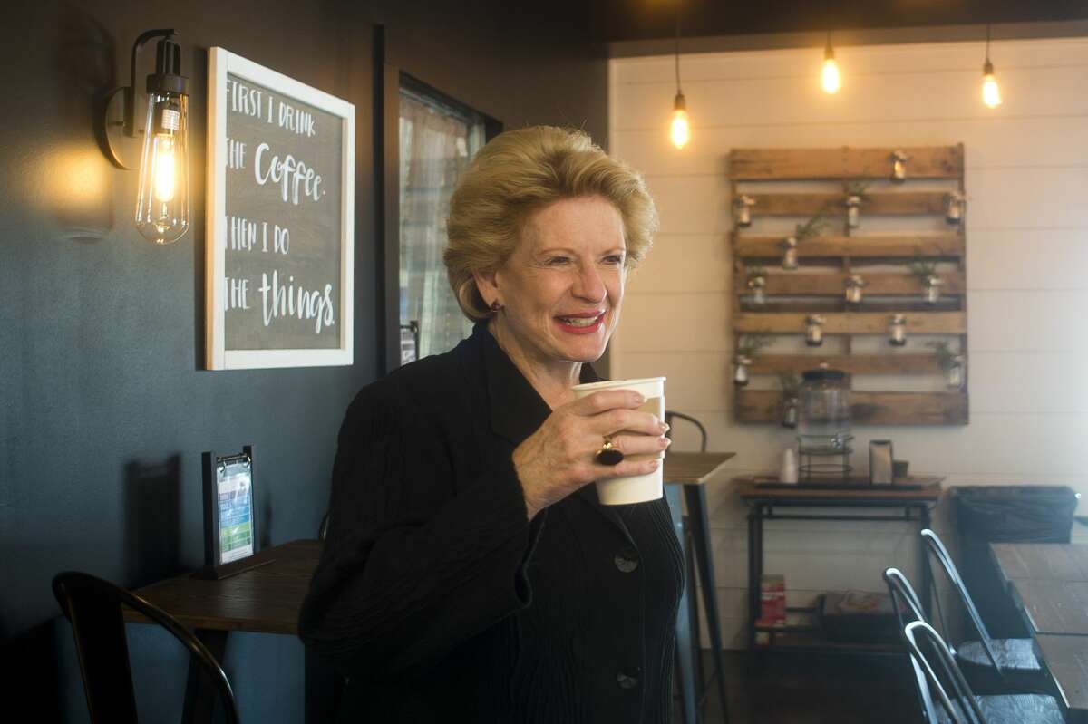 U.S. Sen. Debbie Stabenow takes a sip from a caramel latte at Live Oak Coffeehouse during an afternoon of visiting small businesses in Midland on Wednesday, August 23, 2017.
