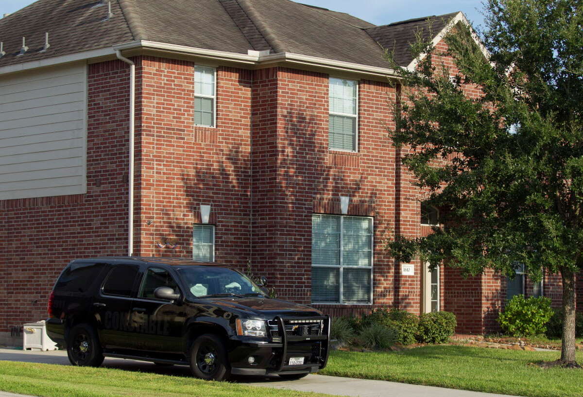 A deputy's vehicle with the Montgomery County Precinct 3 Constable's Office is seen at a home in the 1600 block of Julia Park Lane where nine children were taken after the mother and father were arrested and charged with child endangerment, Wednesday, Aug. 23, 2017, in Spring. One child was transported to Texas Children?•s Hospital, while the other eight were put into custody of Child Protective Services.