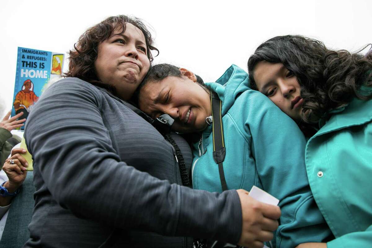 Highland Hospital Nurse Maria Mendoza-Sanchez (left) comforts her daughters Melin Sanchez, 21 (center), and Elizabeth Sanchez, 16, at Highland Hospital in Oakland during a rally and demonstration in support of Ms. Mendoza-Sanchez and her family on Monday, August 14, 2017. Mrs. Mendoza-Sanchez and her husband may have to return to Mexico after their request their request for a stay of deportation was denied.