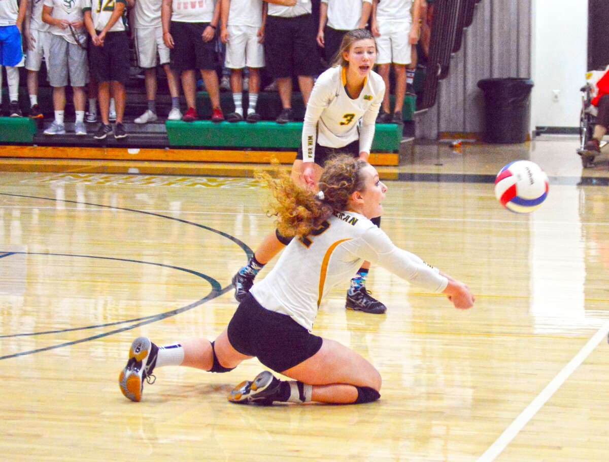 MELHS senior Madeline Stewart successfully makes a dig during the first game against Alton in Wednesday’s season-opening match for the Knights.