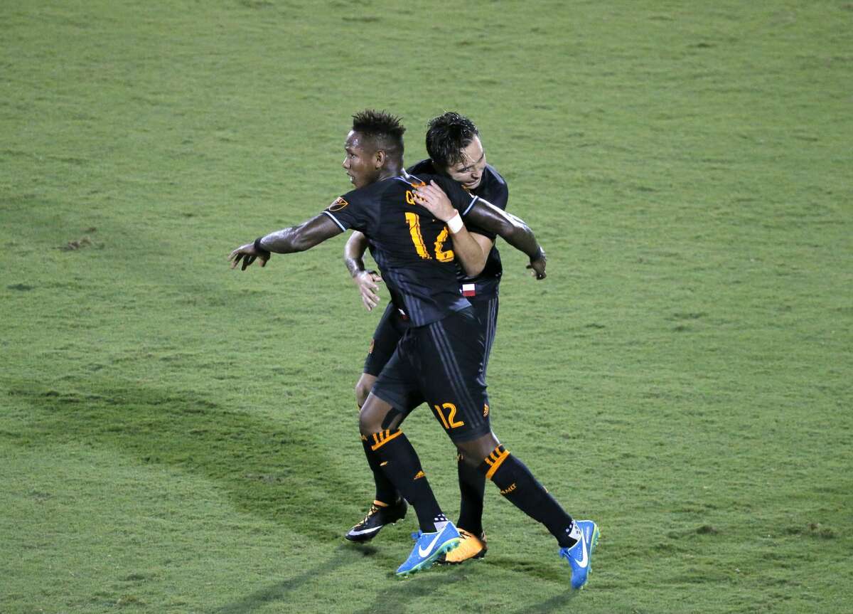 Houston Dynamo' Romell Quioto (12) and Erick Torres, rear, celebrate a goal by Torres in the second half of an MLS soccer game against FC Dallas on Wednesday, Aug. 23, 2017, in Frisco, Texas. (AP Photo/Tony Gutierrez)