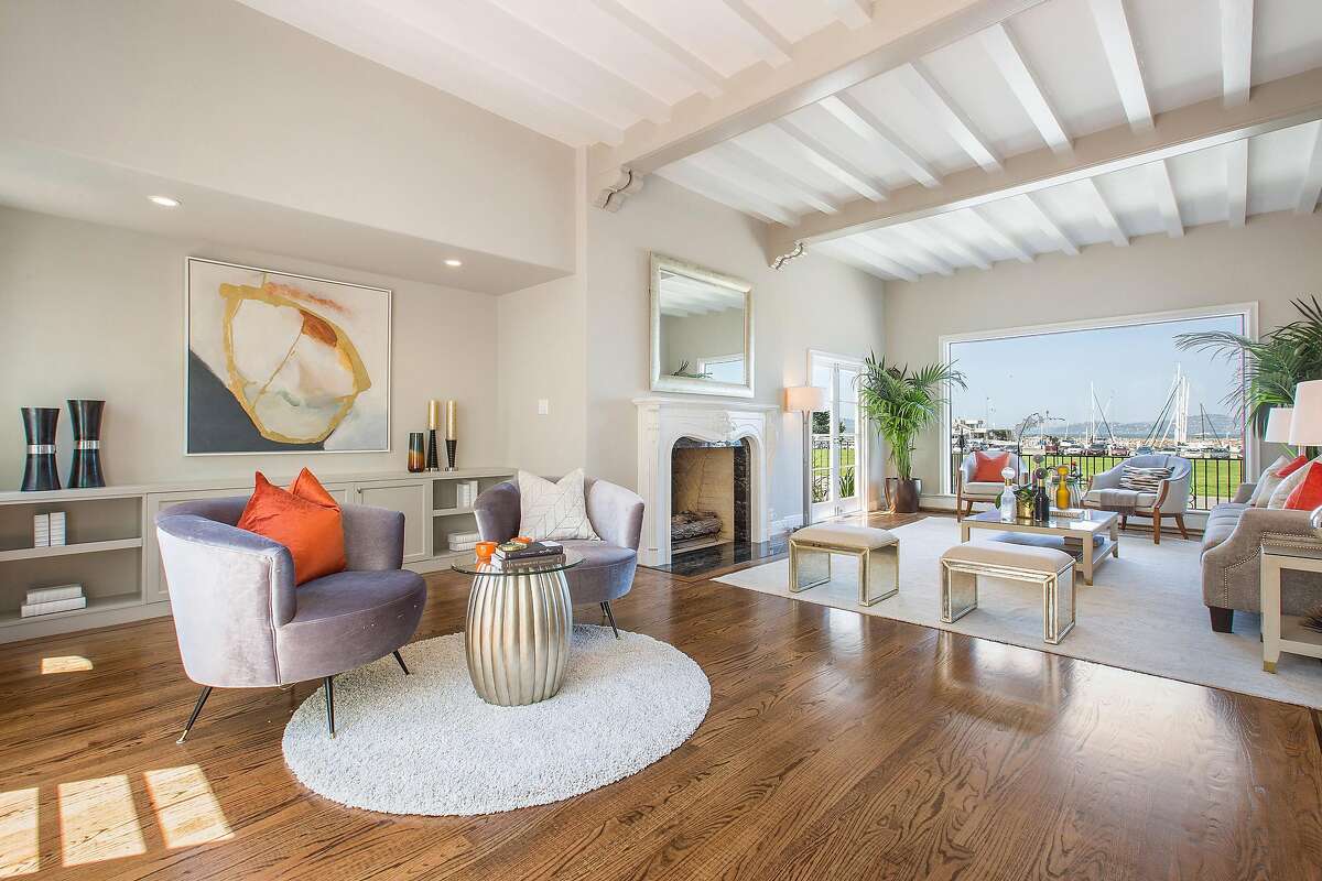 The spacious living room features a fireplace and unobstructed views of the bay and Marina Green.