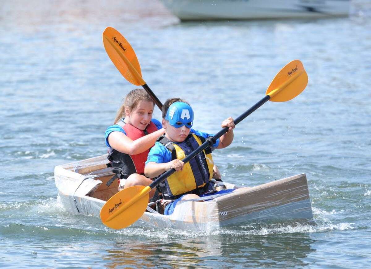 Cos Cob residents David Zelenz, 11, front, and his siter Marina Zelenz, 12, propel the Captain America kayak during the SoundWaters HarborFest 16 cardboard kayak race on Stamford Harbor off Harbor Point, Stamford, Conn., Saturday, Aug. 27, 2016. The Stamford kayak "Tribe" propelled by the duo of Griffin Gigliotti and Angus Manion took first place in the championship race.