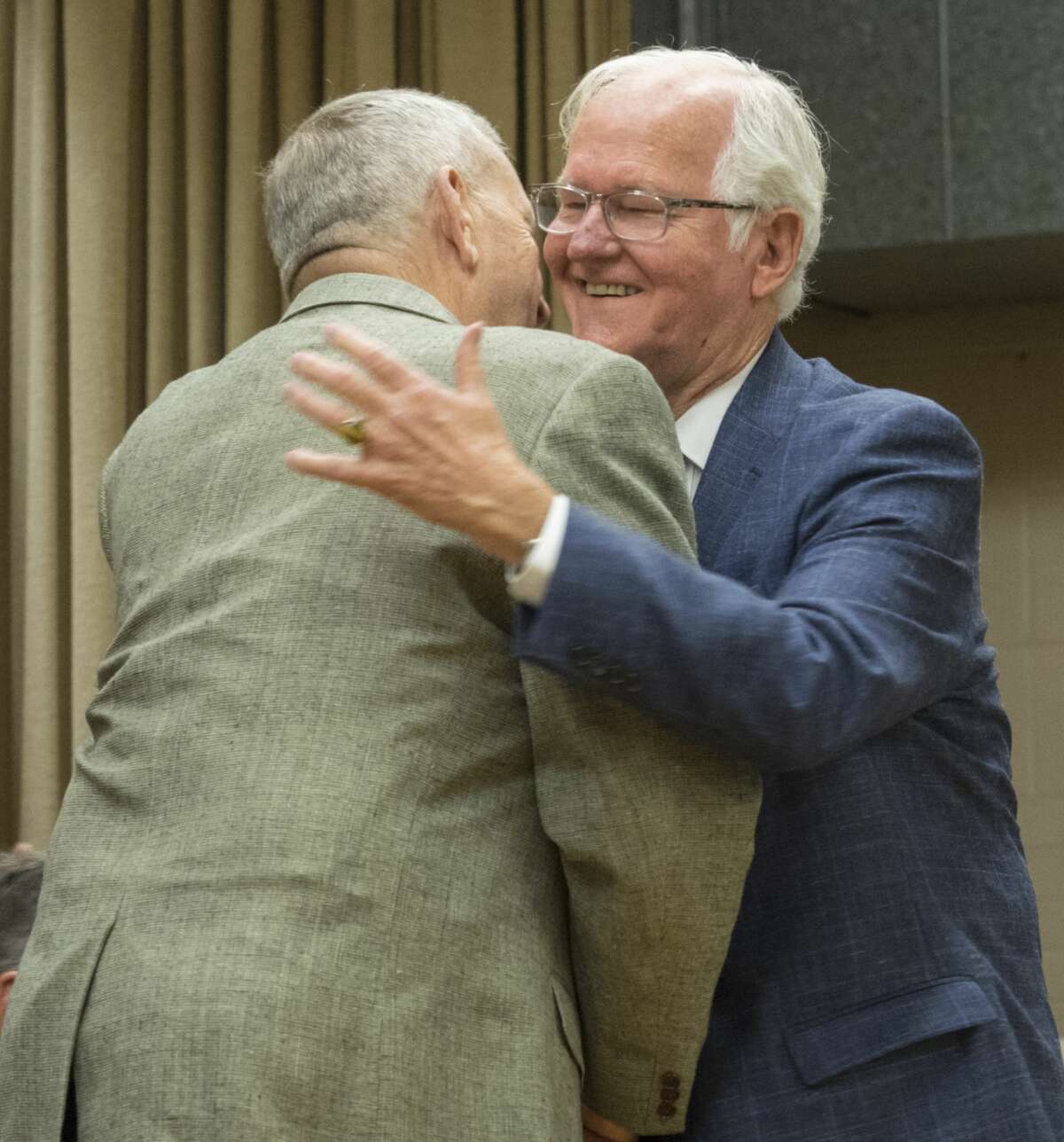 Midland County Judge Mike Bradford, right, gets a hand shake and a hug after introducing retired U.S. Army Gen. Tommy Franks during the Aug. 24 dedication of General Tommy Franks Elementary. A leadership program presented by The General Tommy Franks Leadership Institute is planned for June at Midland College.