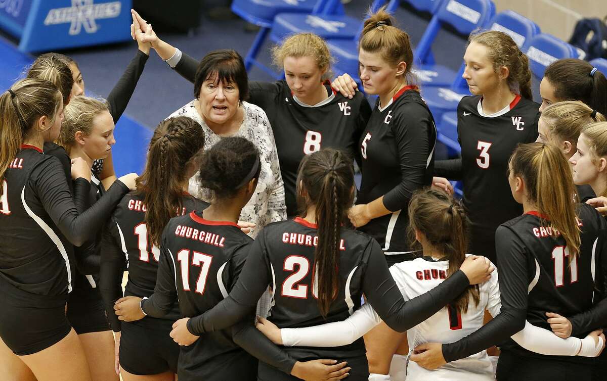 Churchill coach Jo Anne Hultgren huddles with the team during a volleyball match against O’Connor held on Aug. 7, 2017 at Northside Sports Gym.